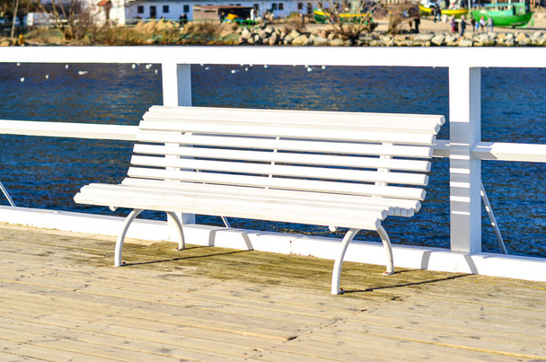 A white bench on the pier in Orlowo, Gdynia, Poland - Photo, image