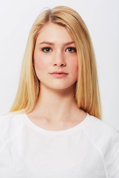 Natural, young and absolutely gorgeous. A pretty young blonde isolated on a white background. - Foto, afbeelding