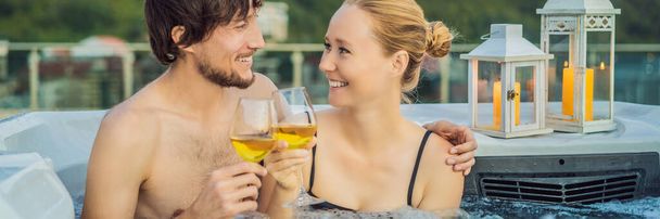 BANNER, LONG FORMAT Portrait of young carefree happy smiling couple relaxing at hot tub during enjoying happy traveling moment vacation life against the background of green big mountains - Fotó, kép