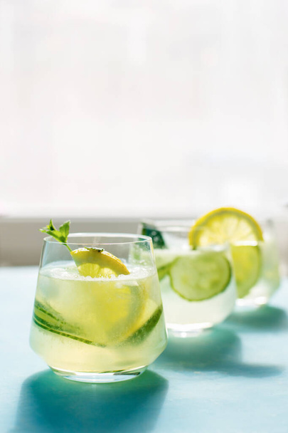 Fresh detox drink with cucumber and lemon slices, with mint. Summer cocktail. Healthy food concept - Fotografie, Obrázek