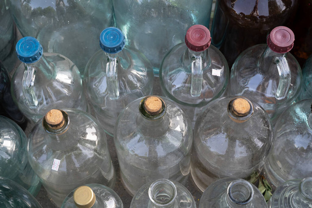 bouteilles et bocaux en verre vides de différentes tailles et couleurs avec bouchons et bouchons de différentes couleurs - Photo, image