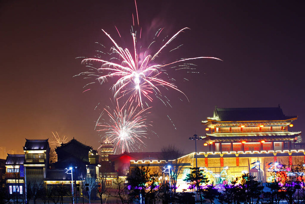 Fireworks up ancient buildings at night, in China - Photo, Image