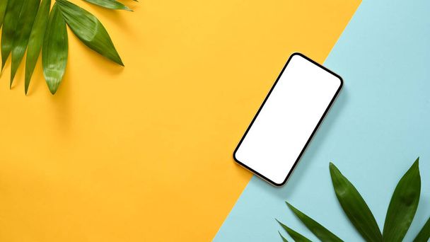 Smartphone white screen mockup for display your graphic on summer beach background. top view - Фото, изображение