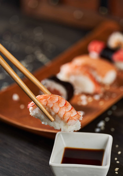 Fresh sushi assortment served on rustic wooden plate - Φωτογραφία, εικόνα