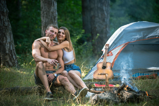 Romantic couple on camping. Outdoor adventure with friends on nature. Sexy coupl travel holidays on nature. - Photo, image