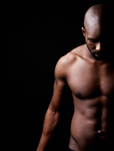 He pushes the limits of perfection. Cropped shot of a muscular man looking down. - Fotoğraf, Görsel