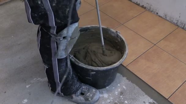 Mixing tile adhesive or cement with power drill tool - Footage, Video