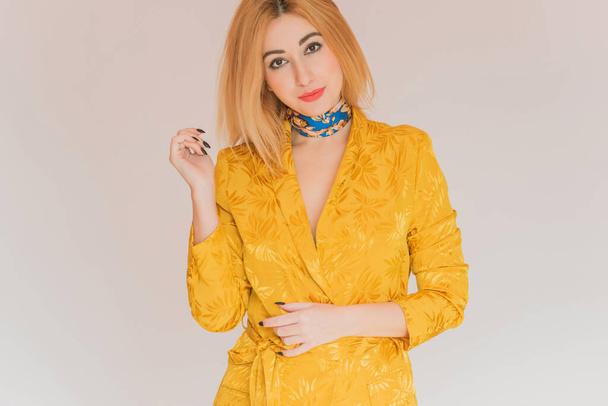 Style for ladies, women in yellow jacket and blue scarf, fashionable concept  - Foto, afbeelding