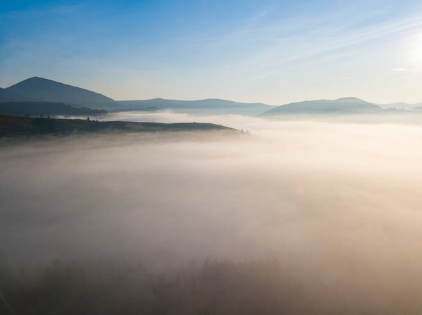 Morning fog in the Ukrainian Carpathians. Aerial drone view. - Фото, изображение