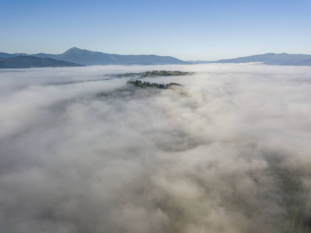 Morning fog in the Ukrainian Carpathians. Aerial drone view. - Fotó, kép
