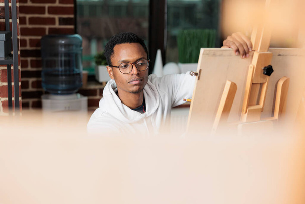 Portret studenta malarstwa patrzącego na model szkicowania wazonu - Zdjęcie, obraz
