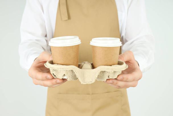 Waiter or barista holds holder with paper cups - Photo, Image
