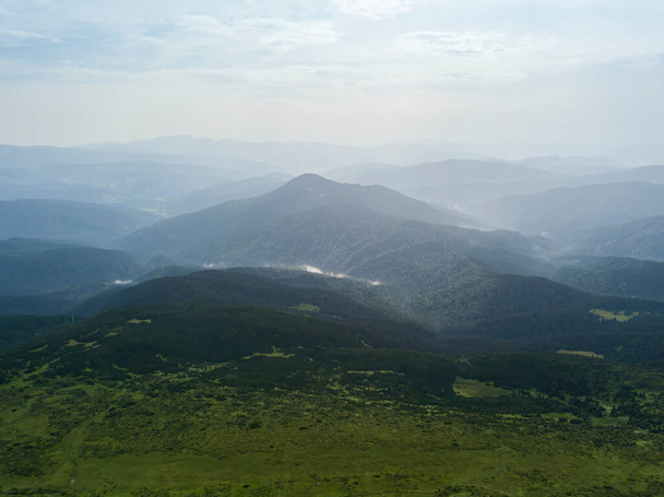High mountains of the Ukrainian Carpathians in cloudy weather. Aerial drone view. - 写真・画像
