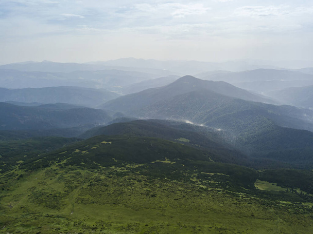 High mountains of the Ukrainian Carpathians in cloudy weather. Aerial drone view. - Фото, изображение