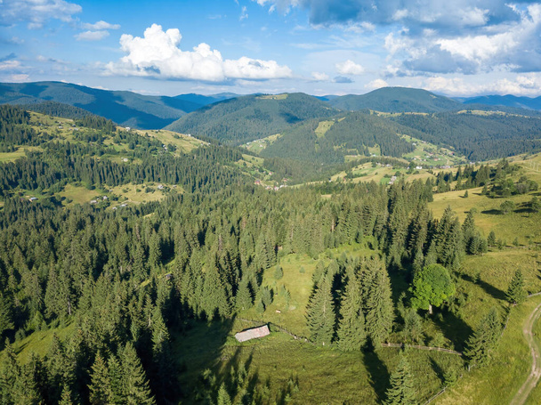 Green mountains of Ukrainian Carpathians in summer. Sunny day, rare clouds. Aerial drone view. - Photo, Image