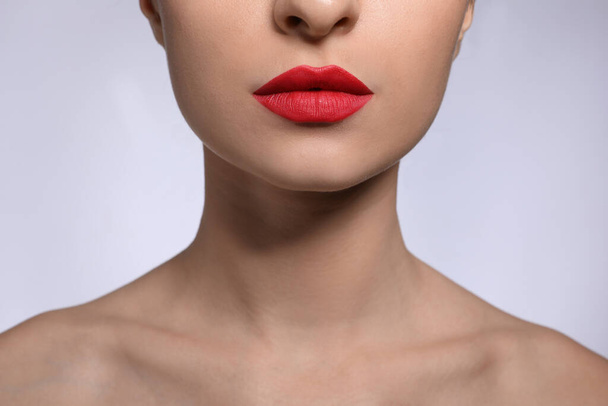 Young woman with beautiful lips makeup on light background, closeup - Fotoğraf, Görsel
