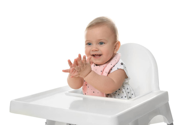 Cute little baby wearing bib in highchair on white background - Photo, Image