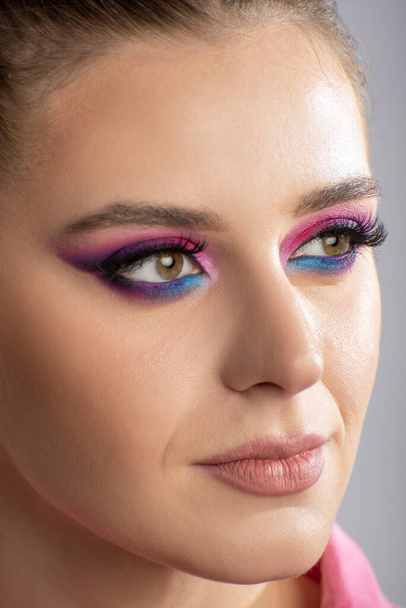 Portrait of beautiful young woman with bright makeup. Pretty girl with vivid eyes. Beauty Fashion woman with perfect pink makeup. Close up, vertical frame. - Φωτογραφία, εικόνα