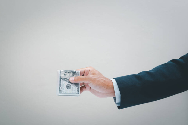Businessman hand holding usd. dollar banknote. Business and financial concept. - Φωτογραφία, εικόνα