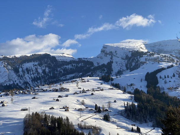 雪に覆われた高山の牧草地と冬の服装でアルプシュタイン塊の岩のピーク(付録アルプスの塊), Unterwasser -サンガレンのカントン,スイス(スイス)) - 写真・画像
