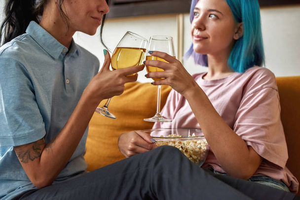 Two lovely women holding champagne glasses, closeup - Fotó, kép