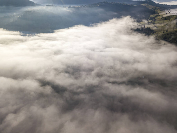 Morning mist in Ukrainian Carpathian mountains. Aerial drone view. - Fotó, kép