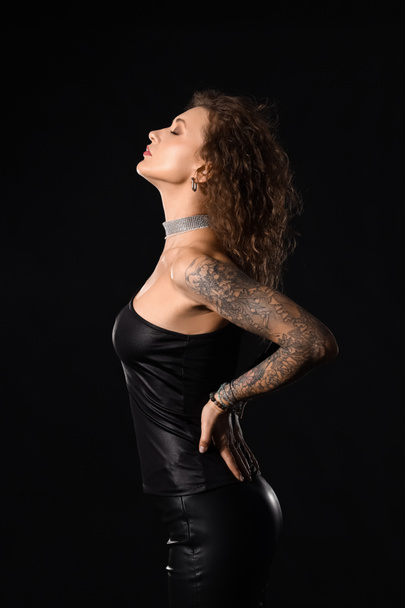 Beautiful fashionable tattooed woman on black background - Fotó, kép