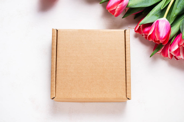 Carton, cardboard box decorated with spring fresh tulip - 写真・画像