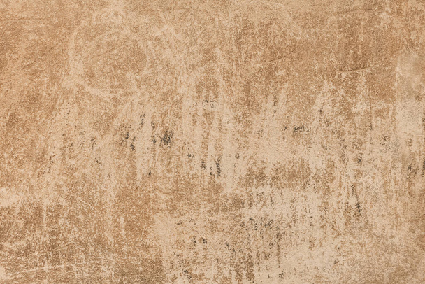 A plaster wall texture with rough scratches. An old beige painted wall background. - Foto, imagen