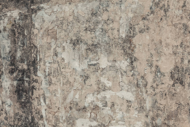 A dirty old plaster wall texture. A weathered and damaged painted wall background. - 写真・画像