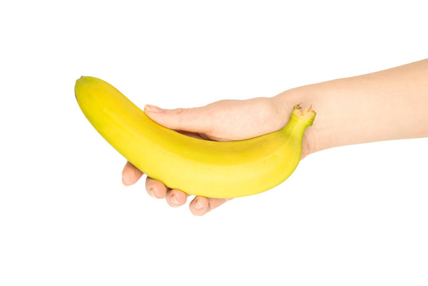Een bos bananen in de hand van een vrouw geïsoleerd op een witte achtergrond. - Foto, afbeelding
