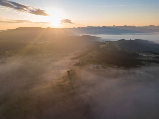 Sunrise over the fog in the Ukrainian Carpathians. Aerial drone view. - Фото, изображение