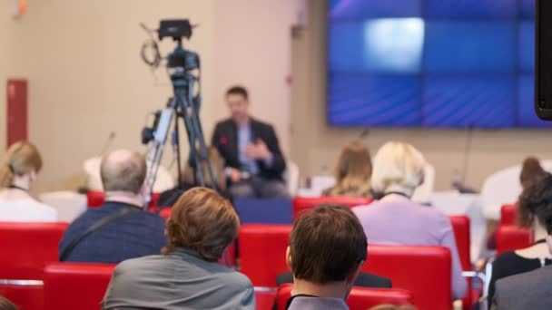Business seminar participants sitting near camera during speech - Footage, Video