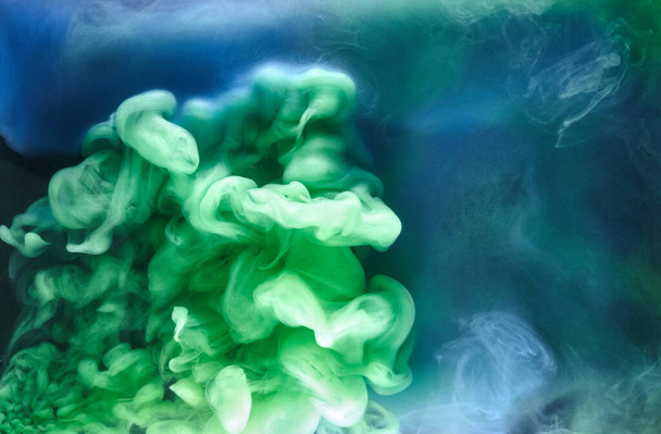 Blue green smoke on black ink background, colorful fog, abstract swirling ocean sea, acrylic paint pigment underwater - Fotoğraf, Görsel