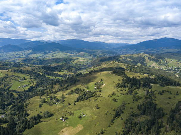 Green mountains of Ukrainian Carpathians in summer. Coniferous trees on the slopes. Aerial drone view. - Photo, Image