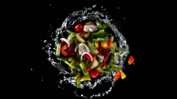 Super slow motion of rotating fresh lettuce flying up in the air. Splashing water. Isolated on black background. Filmed on high speed cinema camera, 1000 fps. - Filmati, video