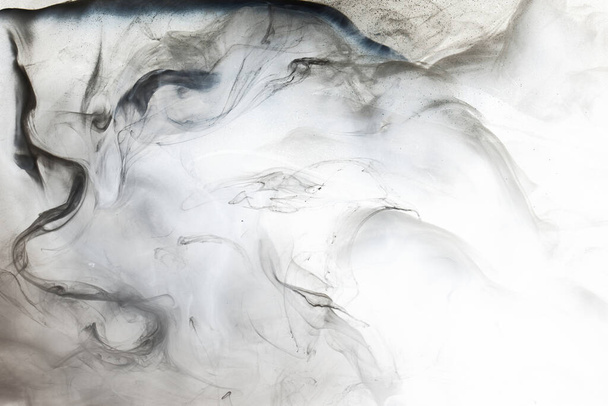 Dark smoke on white ink background, colorful fog, abstract swirling ocean sea, acrylic paint pigment underwater - Фото, изображение