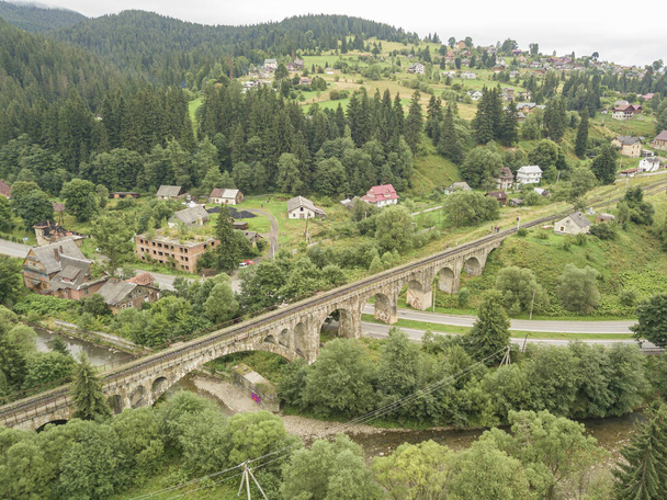 Old railway bridge in the mountains. Ukrainian Carpathians. Aerial drone view. - Photo, Image
