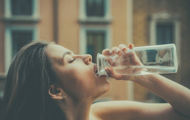 Girl drinking water outdoor. Sensual young woman. Stay hydrated. City portrait. Fashion and beauty. - Foto, Imagen