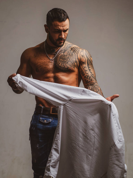 Sexy man undressing shirt. Sexual desire. Sensual guy. - Fotografie, Obrázek