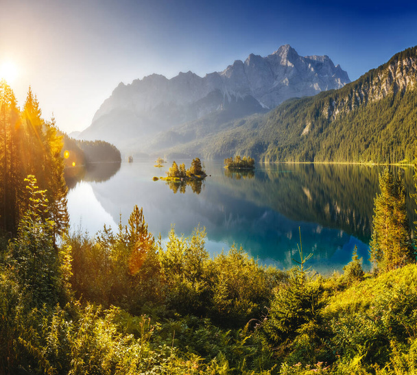 View of the islands and turquoise water at Eibsee Lake at the foot of Mt. Zugspitze. Morning scene. Location famous resort Garmisch-Partenkirchen, Bavarian alp, Europe. Artistic picture. Beauty world. - Photo, Image