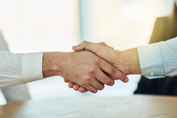 Welcome aboard to the best in business. Cropped shot of two businessmen shaking hands in a modern office. - Photo, Image