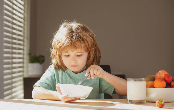 Child eat. Little healthy hungry boy eating soup from with spoon. - Φωτογραφία, εικόνα