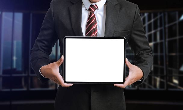 Business man holding and shows touch screen tablet with digital device, technology for smart working concept - Photo, Image