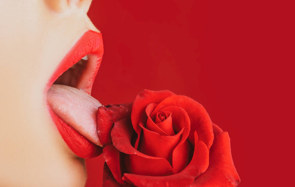 Passionate red lips with red lipstick closeup. Beautiful woman lips with red rose. - Foto, afbeelding