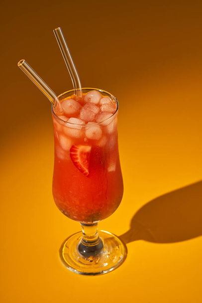 Summer strawberry punch cocktail with ice on yellow background - Фото, зображення