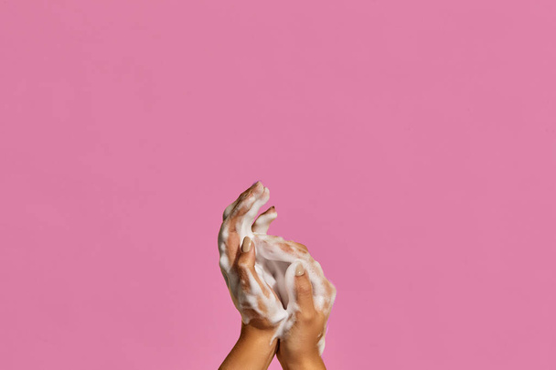 Two hands with hand soap foam on colorful background with copy space. - Fotografie, Obrázek