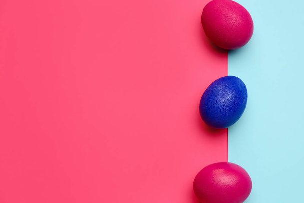 Painted Easter eggs on color background, top view - Photo, Image