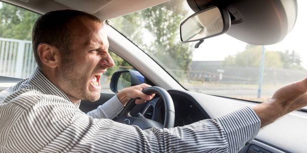 Angry driver gesturing bad, road rage theme - 写真・画像