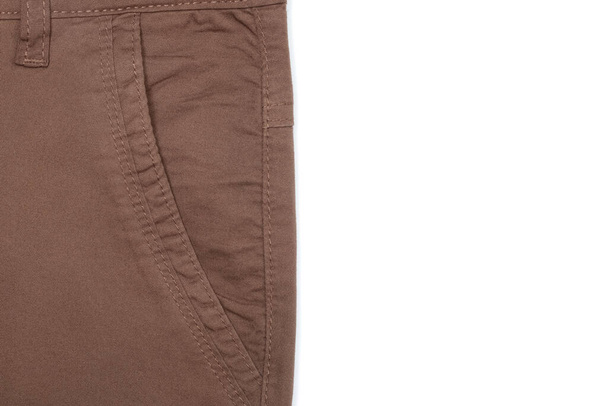 Close up of side pocket of brown pants on white background, copy space on the right. - Photo, Image